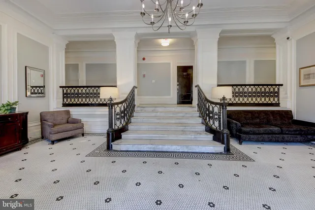 a living room with furniture and a chandelier