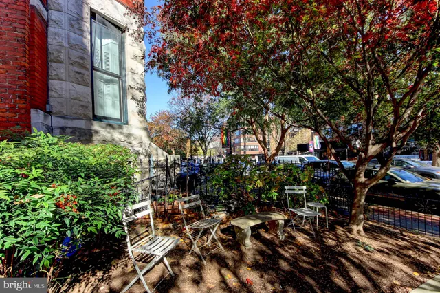 a tall building with trees in front of it