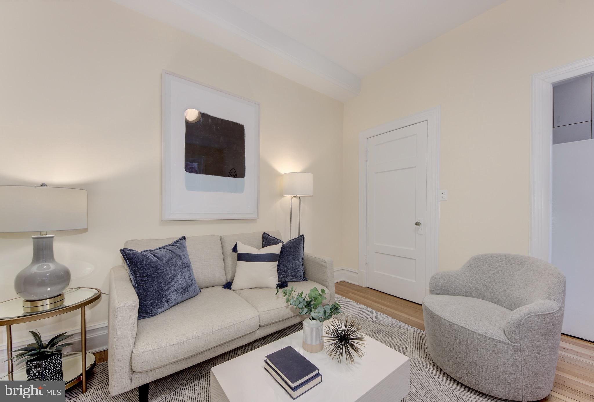 1526 17th Street Northwest, Unit 207 Washington, DC 20036 - Photo 3 of 49 a living room with furniture and a flat screen tv