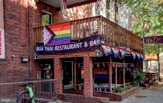 a front view of a building with sitting area