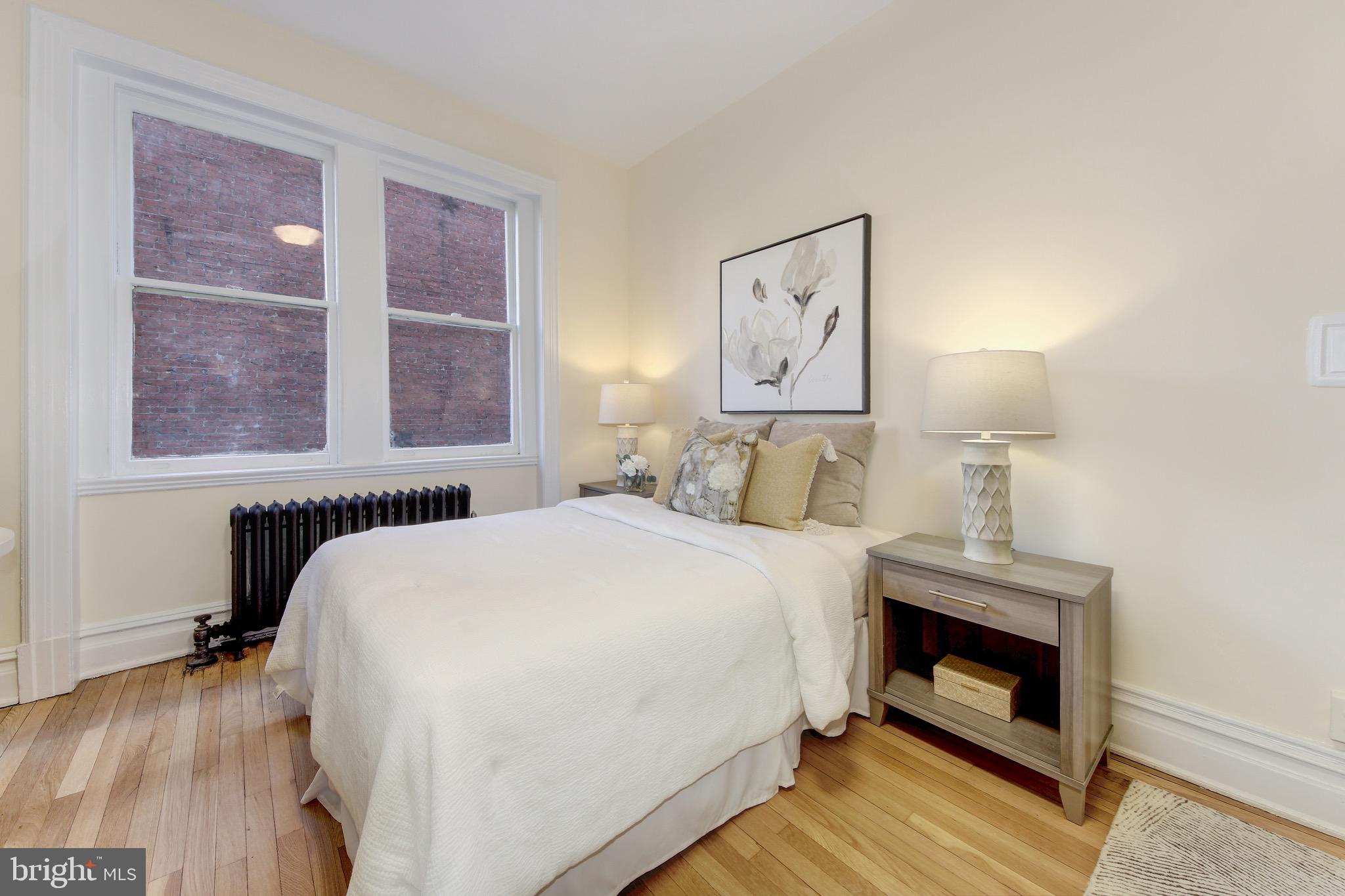 1526 17th Street Northwest, Unit 207 Washington, DC 20036 - Photo 4 of 49 a bedroom with a bed and a fireplace