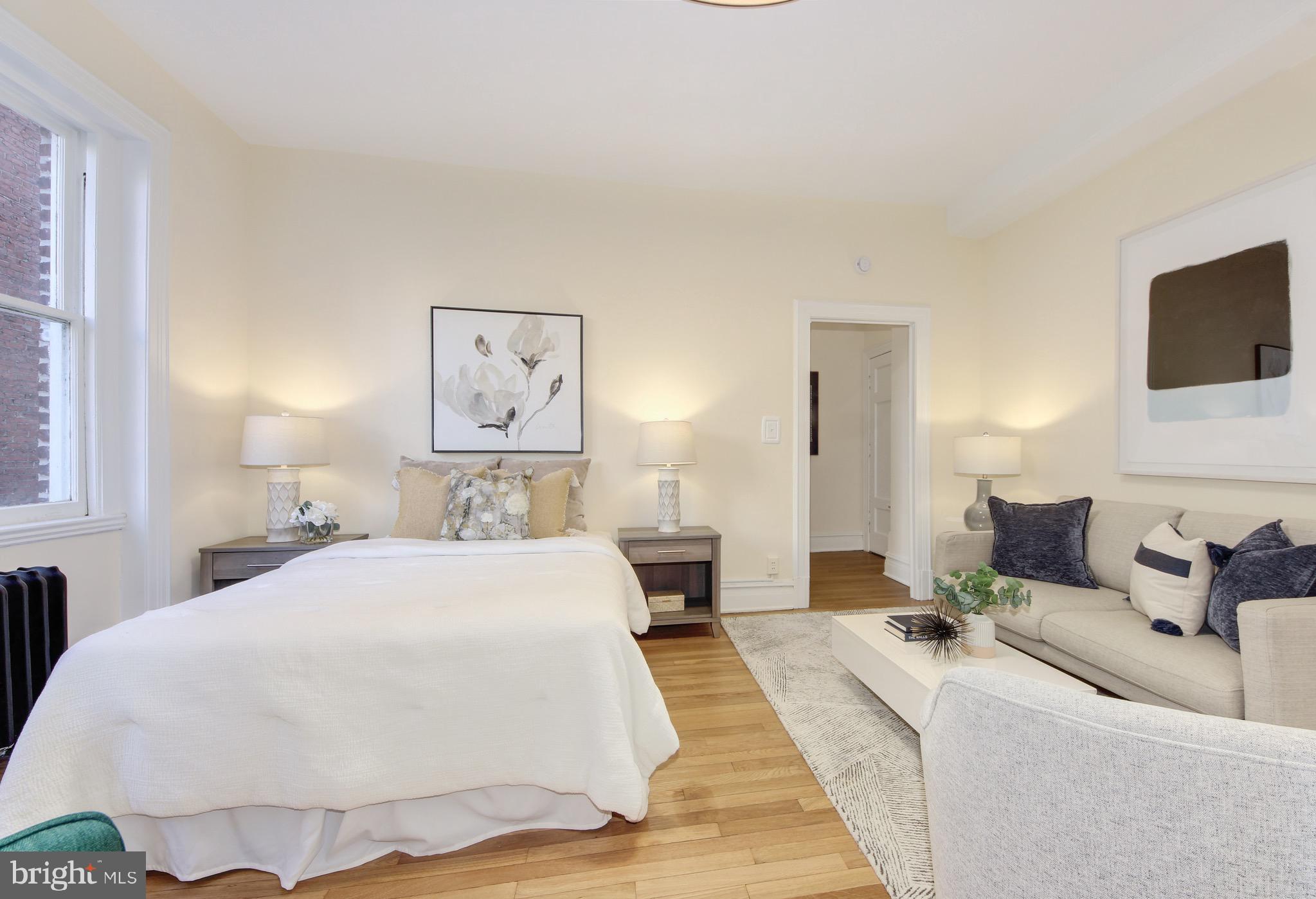 1526 17th Street Northwest, Unit 207 Washington, DC 20036 - Photo 6 of 49 a spacious bedroom with a bed and a flat screen tv