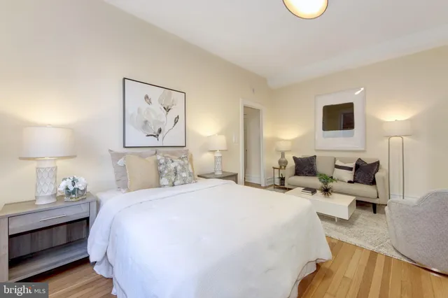 a spacious bedroom with a bed and lamp