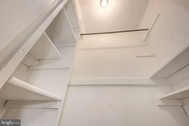 a room with a refrigerator and a window