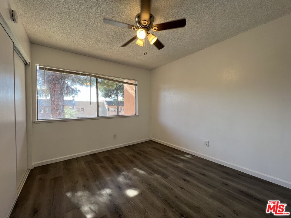 418 West Jackson Street Rialto, CA 92376 - Photo 17 of 24 a view of an empty room with window and chandelier fan