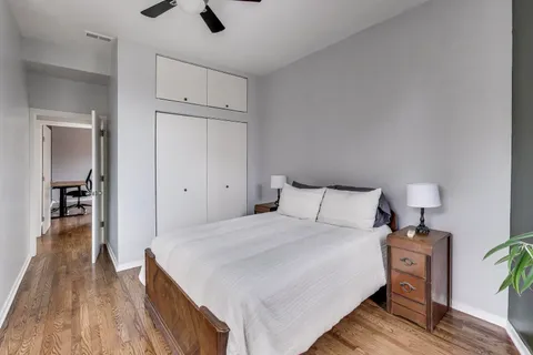 a bedroom with a bed and a chandelier