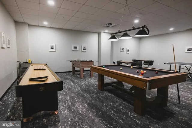 a room with furniture pool table and a projector