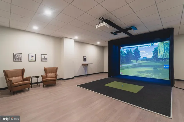 a living room with projector and a flat screen tv