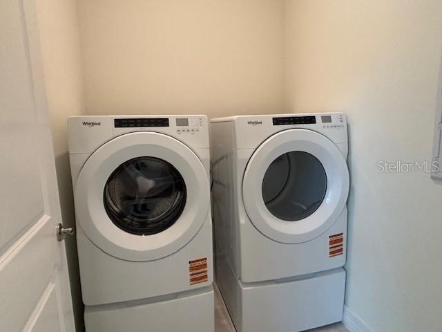 3975 Kennebunk Loop Mount Dora, FL 32757 - Photo 11 of 13 a utility room with dryer and washer