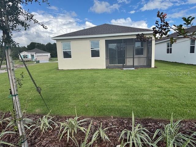 3975 Kennebunk Loop Mount Dora, FL 32757 - Photo 13 of 13 a front view of a house with a garden