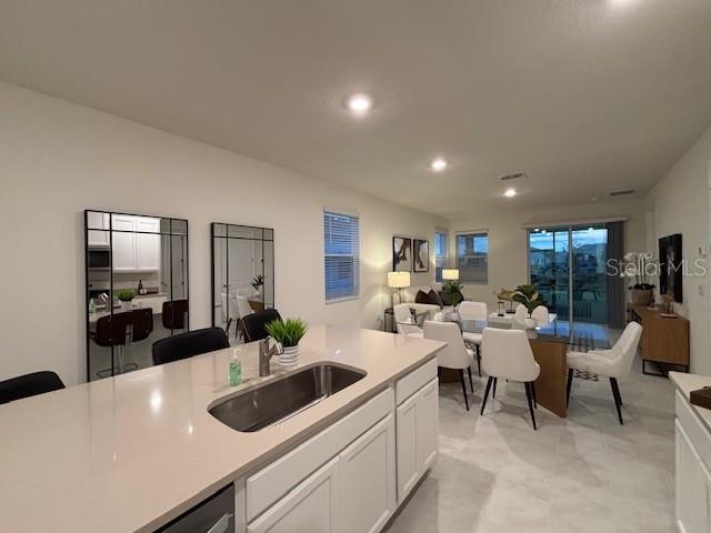 3975 Kennebunk Loop Mount Dora, FL 32757 - Photo 4 of 13 a kitchen with a sink a counter and chairs