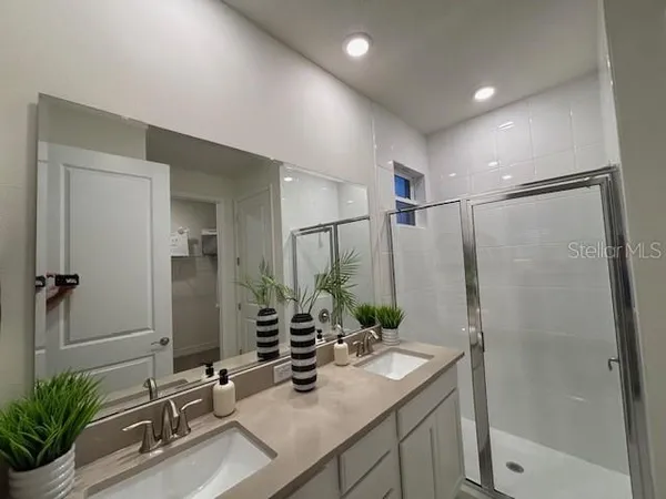 a bathroom with a double vanity sink and a mirror