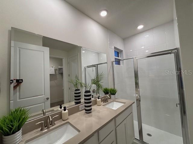 3975 Kennebunk Loop Mount Dora, FL 32757 - Photo 8 of 13 a bathroom with a double vanity sink and a mirror