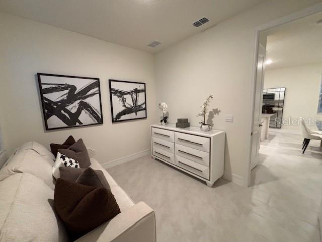 3975 Kennebunk Loop Mount Dora, FL 32757 - Photo 10 of 13 a living room with furniture and a painting on the wall