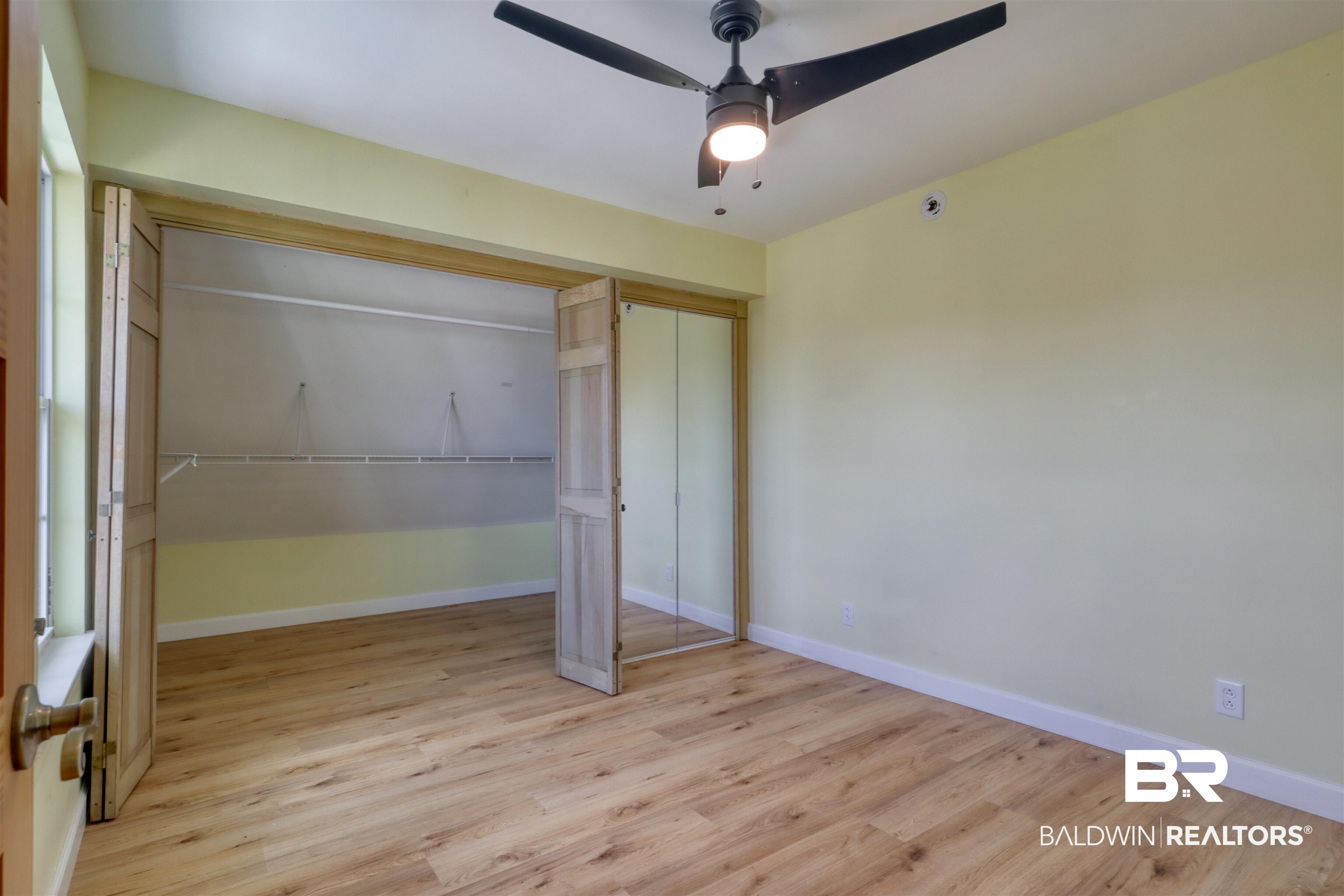 28461 Gardner Road Elberta, AL 36530 - Photo 20 of 46 Unfurnished bedroom with light wood-style flooring, ceiling fan, and a closet
