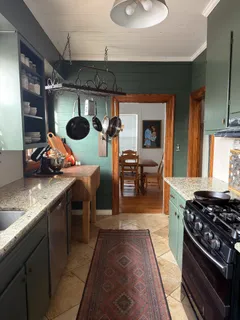 a kitchen with a stove and a wooden floors