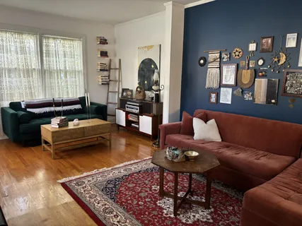 a living room with furniture and wooden floor