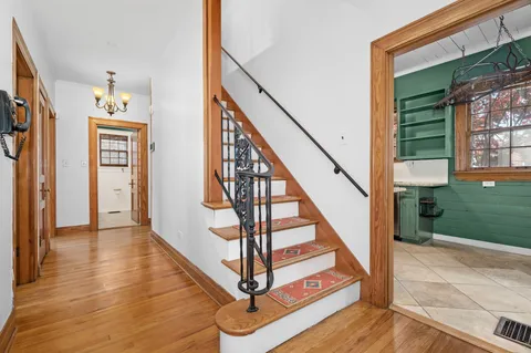 a view of entryway and hall with wooden floor
