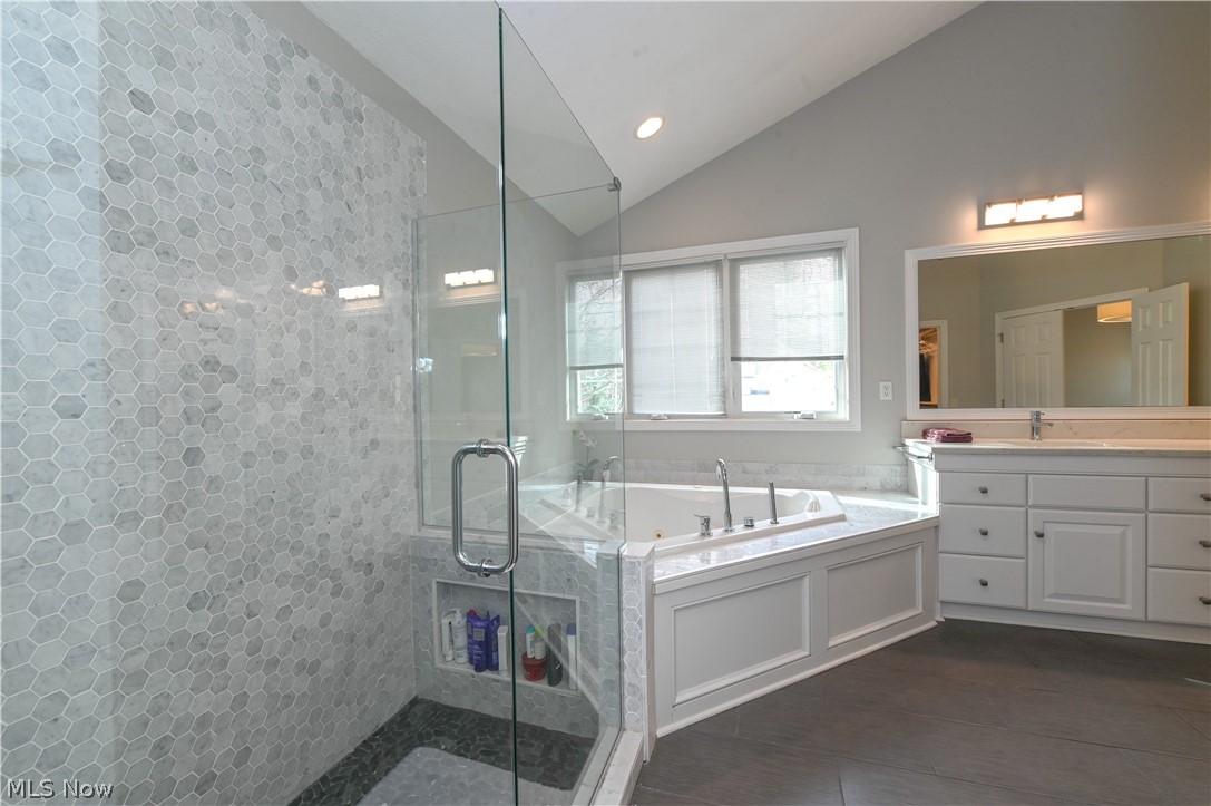 1688 Sheridan Road South Euclid, OH 44121 - Photo 18 of 48 Bathroom with vanity, vaulted ceiling, and plus walk in shower