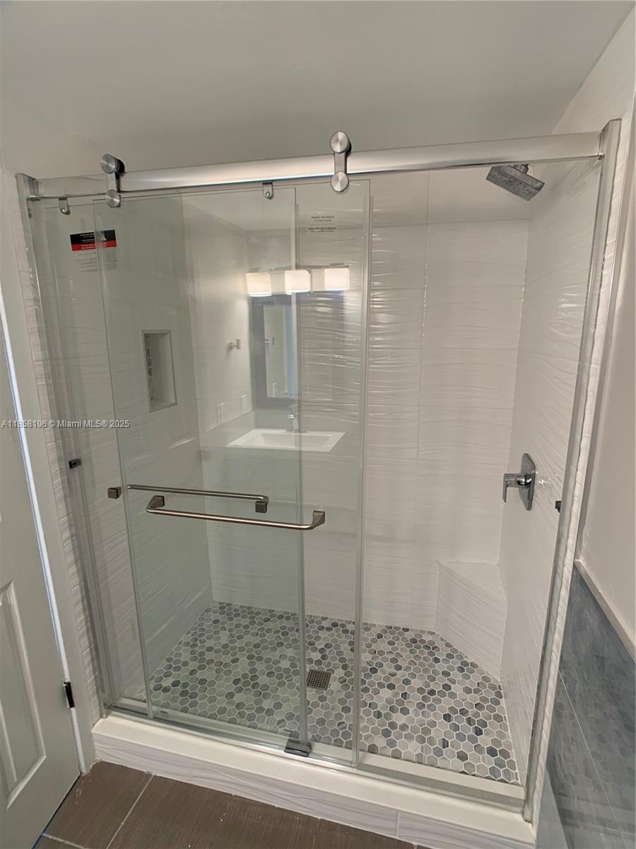 1308 Drexel Avenue, Unit 105 Miami Beach, FL 33139 - Photo 14 of 24 a bathroom with a glass door shower