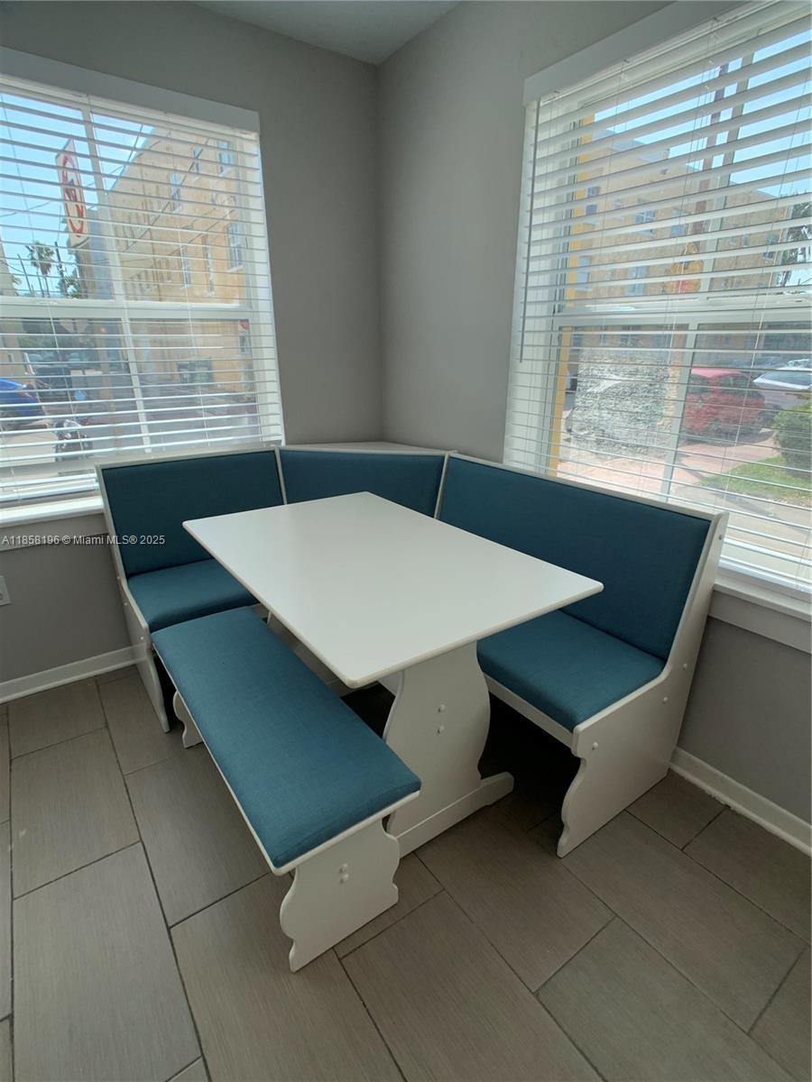 1308 Drexel Avenue, Unit 105 Miami Beach, FL 33139 - Photo 17 of 24 a room with table and windows