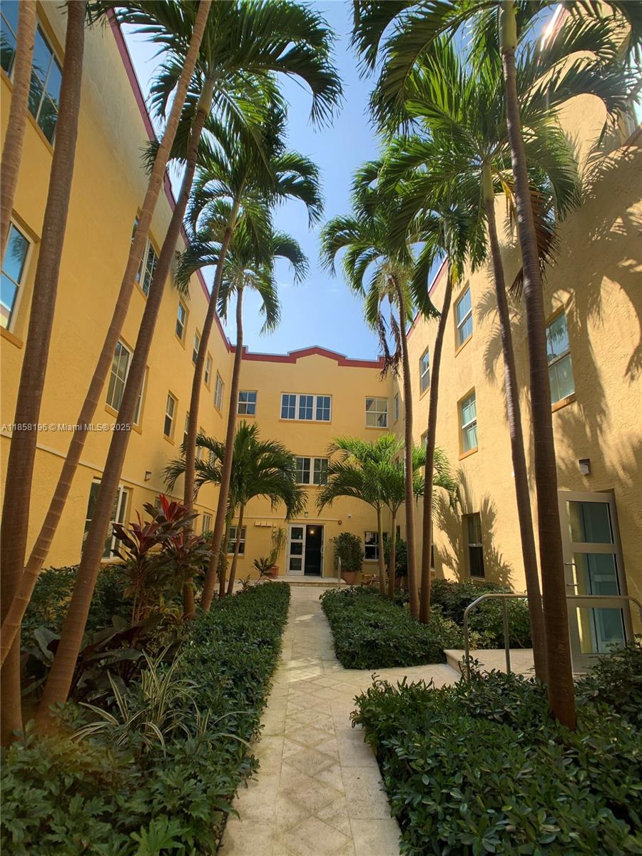 1308 Drexel Avenue, Unit 105 Miami Beach, FL 33139 - Photo 2 of 24 a view of a garden with a tree