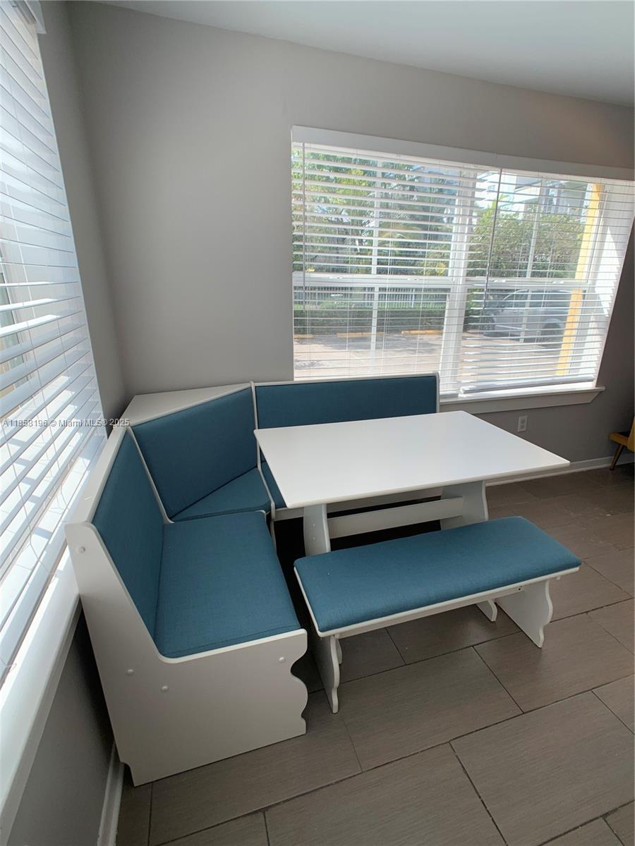 1308 Drexel Avenue, Unit 105 Miami Beach, FL 33139 - Photo 21 of 24 a living room with a furniture and a window
