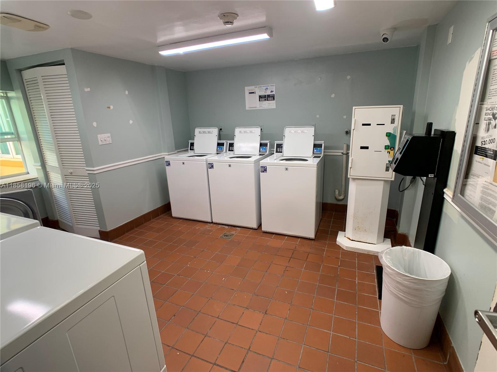 1308 Drexel Avenue, Unit 105 Miami Beach, FL 33139 - Photo 4 of 24 a utility room with cabinets washer and dryer