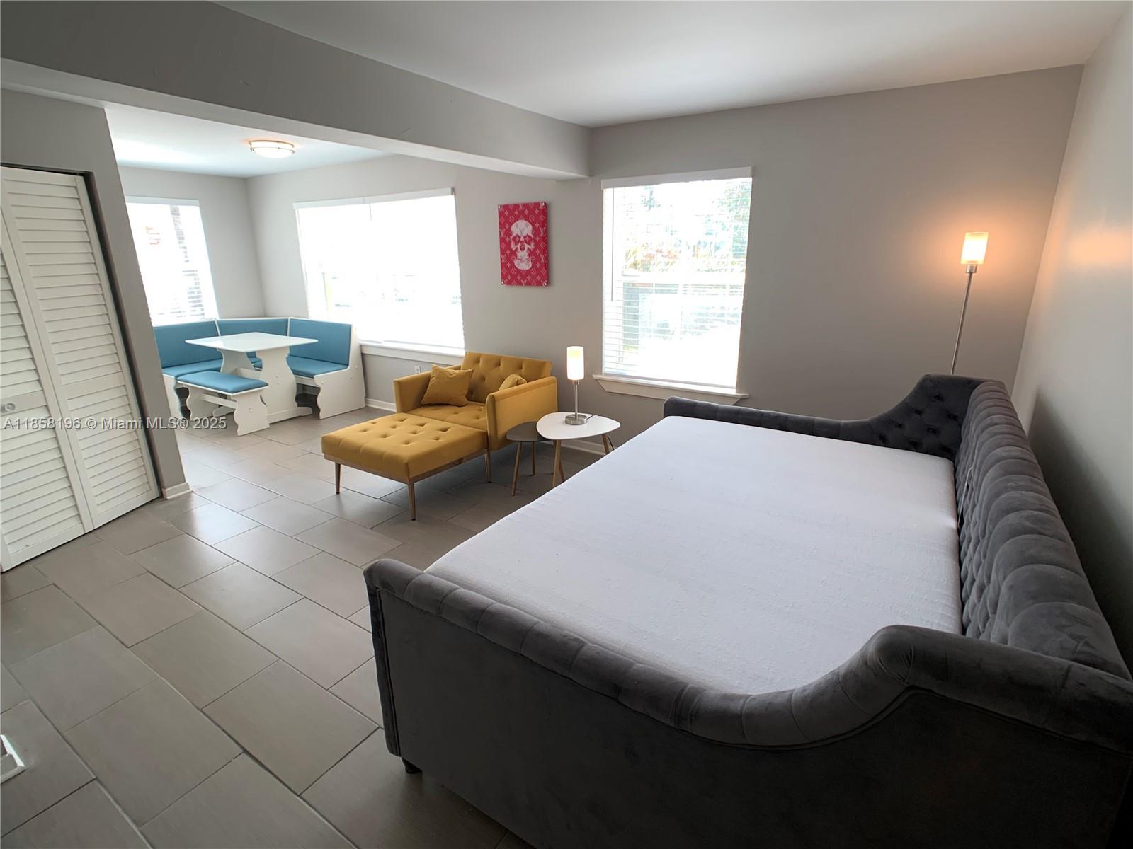 1308 Drexel Avenue, Unit 105 Miami Beach, FL 33139 - Photo 7 of 24 a bedroom with furniture and a window