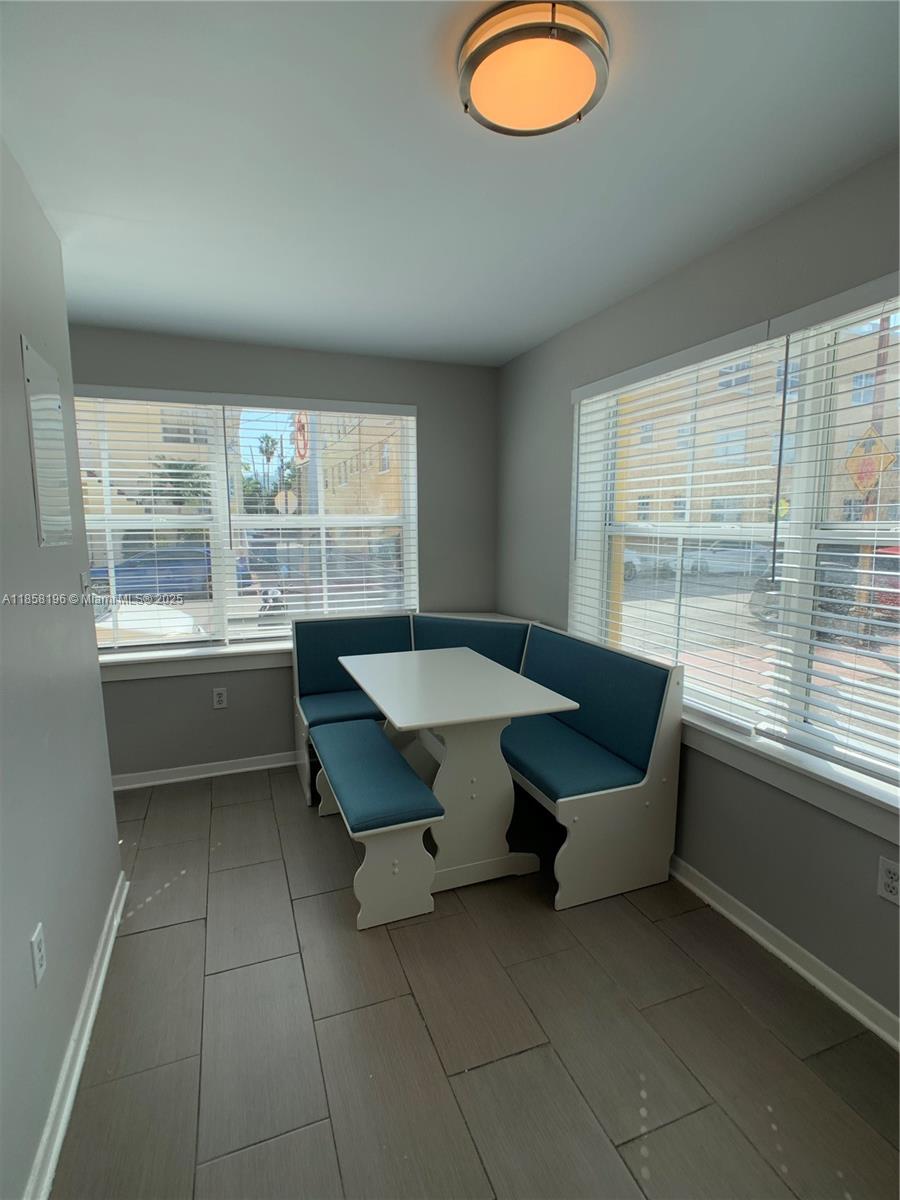 1308 Drexel Avenue, Unit 105 Miami Beach, FL 33139 - Photo 10 of 24 a living room with furniture and a large window