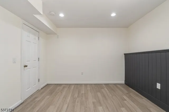 a view of an empty room and wooden floor