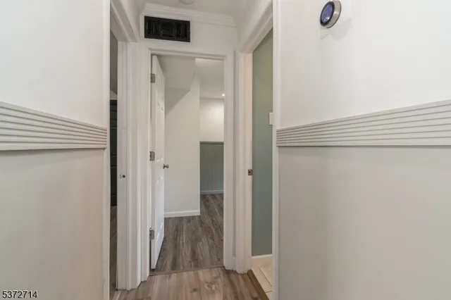 a view of a hallway with wooden floor