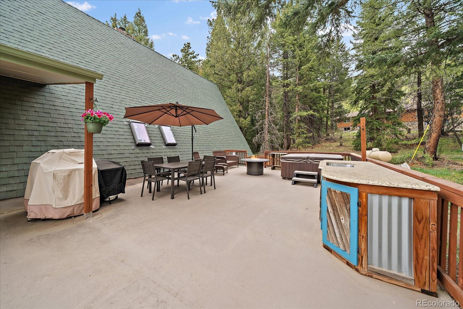 307 Snyder Mountain Road Evergreen, CO 80439 - Photo 6 of 41 an outdoor space with furniture and umbrella