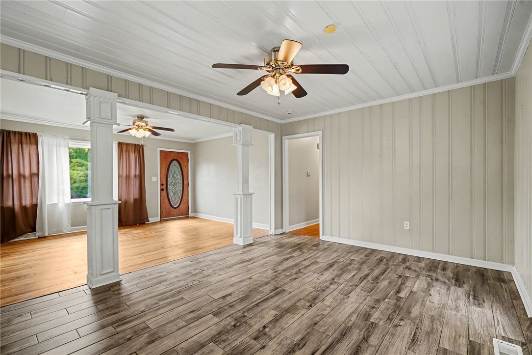 798 Coneross Creek Road Seneca, SC 29678 - Photo 14 of 34 This bright living space showcases a blend of rich wood and cool-toned flooring, promising comfort and charm.