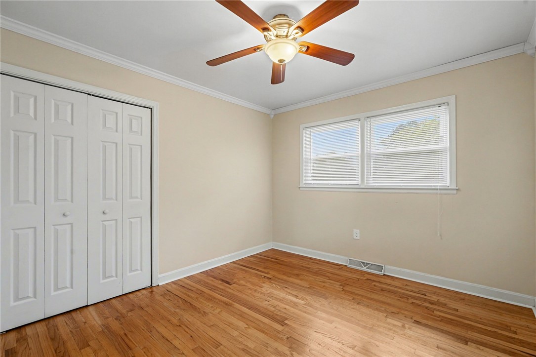 798 Coneross Creek Road Seneca, SC 29678 - Photo 16 of 34 This spacious bedroom features lustrous hardwood floors and a convenient ceiling fan for ultimate comfort.
