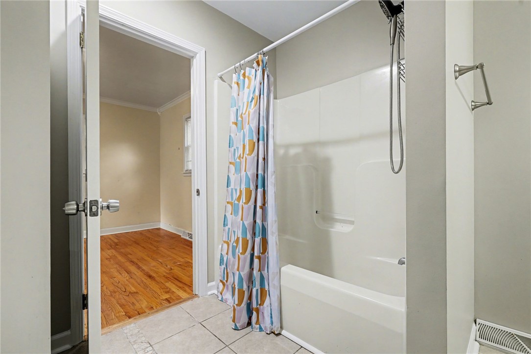 798 Coneross Creek Road Seneca, SC 29678 - Photo 18 of 34 This functional bathroom features a shower-tub combination, with a connecting room offering warm hardwood flooring.