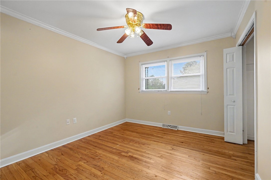 798 Coneross Creek Road Seneca, SC 29678 - Photo 19 of 34 This inviting bedroom features rich hardwood flooring and ample natural light through well-appointed windows.