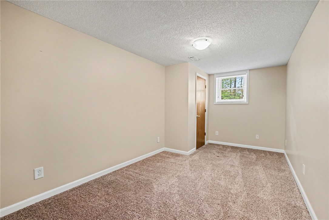 798 Coneross Creek Road Seneca, SC 29678 - Photo 22 of 34 This cozy room offers comfortable carpeting, a natural wood door, and ample natural light.