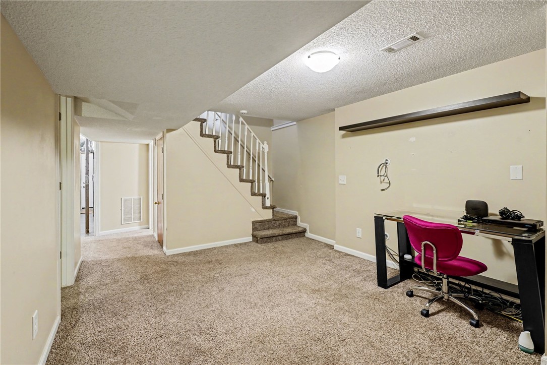 798 Coneross Creek Road Seneca, SC 29678 - Photo 26 of 34 This versatile recreation room features a cozy carpeted floor and convenient staircase access.