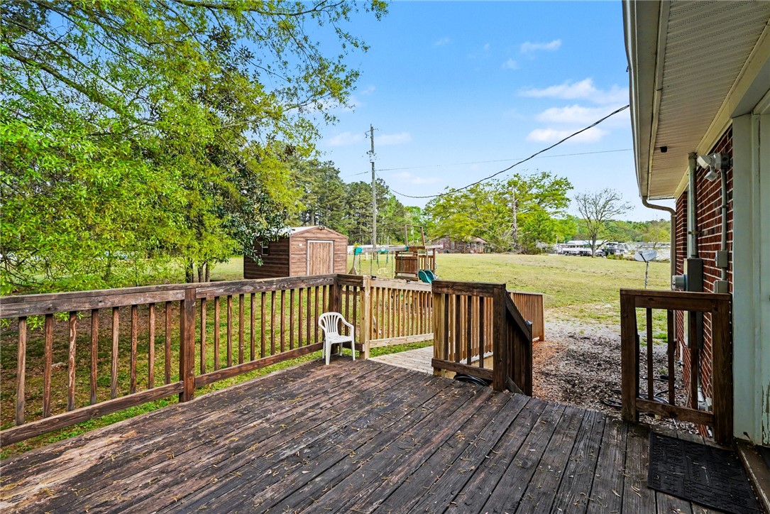 798 Coneross Creek Road Seneca, SC 29678 - Photo 29 of 34 This spacious wooden deck offers serene outdoor living with picturesque natural surroundings and an additional storage shed.