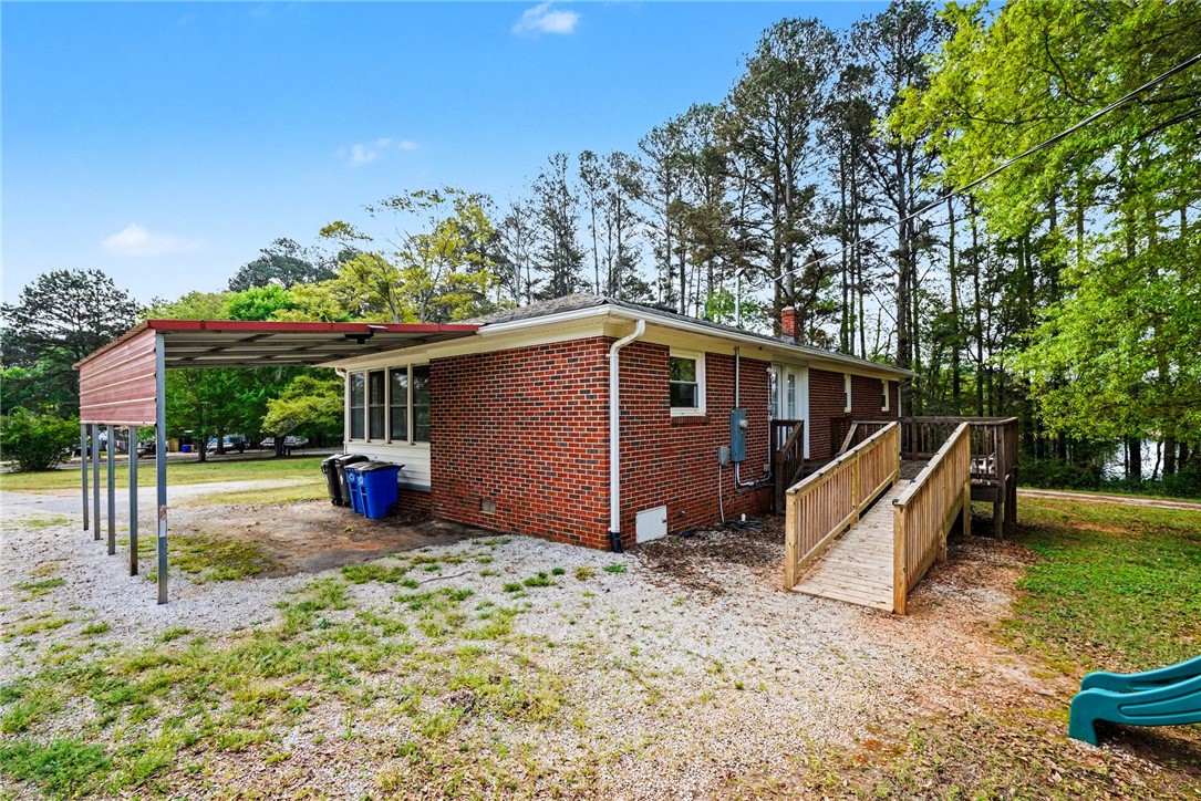 798 Coneross Creek Road Seneca, SC 29678 - Photo 30 of 34 This charming brick home offers outdoor accessibility and ample parking, surrounded by mature trees.