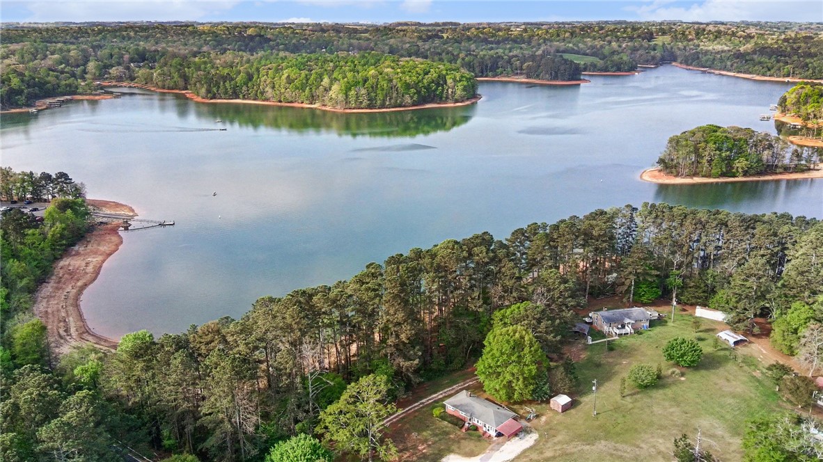798 Coneross Creek Road Seneca, SC 29678 - Photo 4 of 34 This elevated view captures a serene lakeside property nestled amongst lush trees.