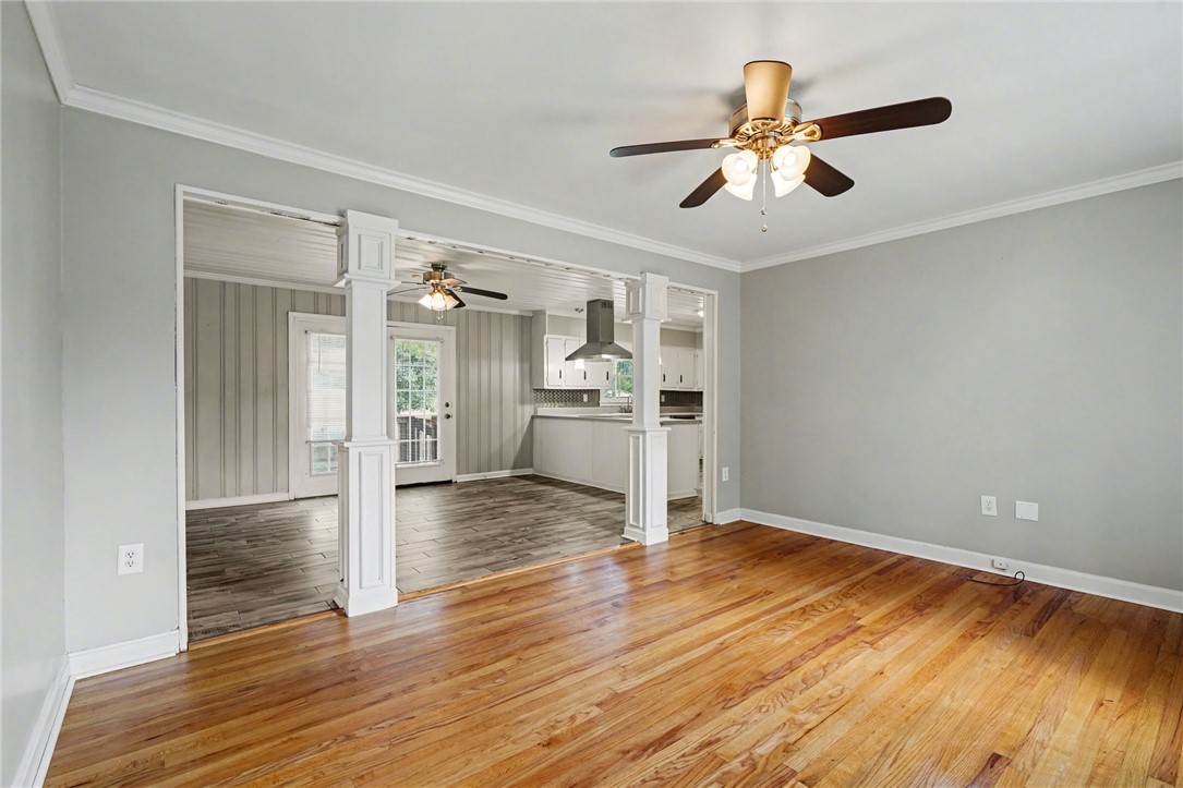 798 Coneross Creek Road Seneca, SC 29678 - Photo 9 of 34 This living space seamlessly flows into the kitchen, creating an inviting atmosphere with hardwood floors.