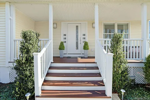 a view of a house with potted plants and wooden floor