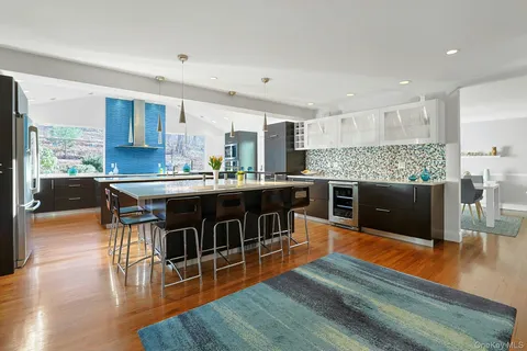 a kitchen with stainless steel appliances granite countertop a stove and a wooden floors