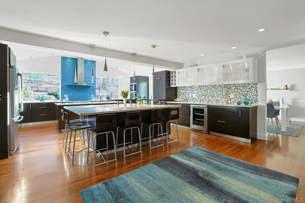 a kitchen with stainless steel appliances granite countertop a stove and a wooden floors