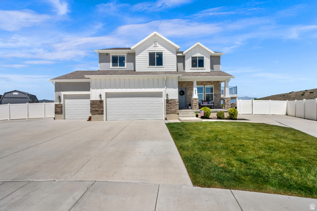 1857 Thunder Gulch Road Eagle Mountain, UT 84005 - Photo 1 of 50 Craftsmam two-story residence featuring a combination of horizontal siding, vertical board and batten siding, and stone veneer accents, abundant parking