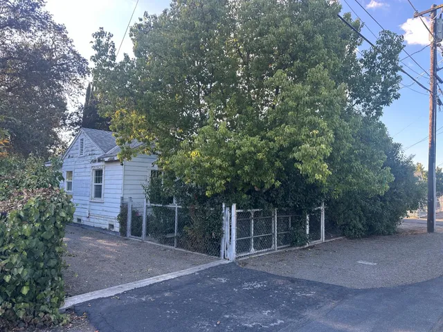 a view of a field with a trees in front of it