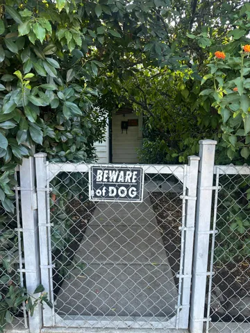 a view of a wooden fence and trees