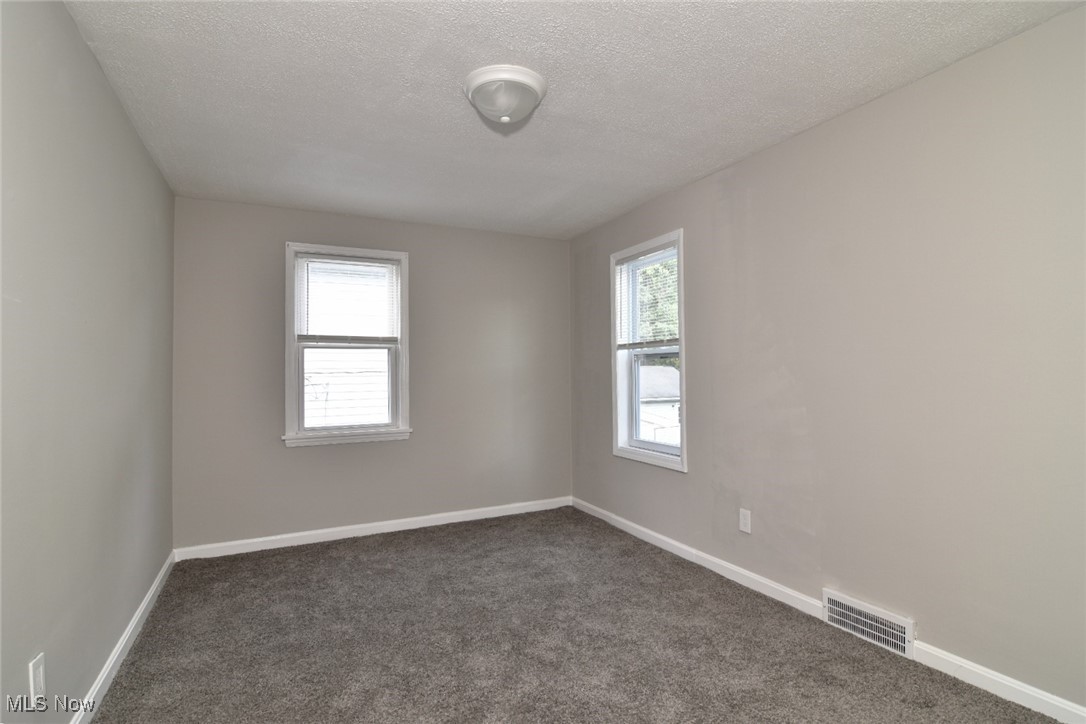1443 Churchill Road Lyndhurst, OH 44124 - Photo 30 of 39 Carpeted spare room with baseboards and a textured ceiling